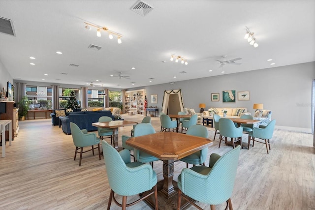 dining space featuring ceiling fan and light wood-type flooring