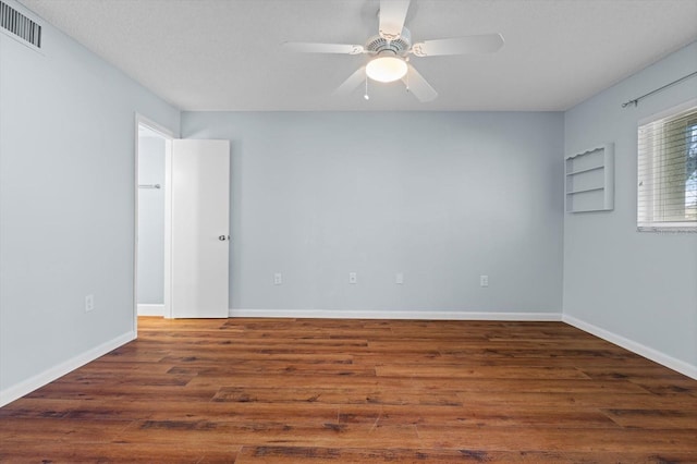 empty room featuring dark hardwood / wood-style floors and ceiling fan