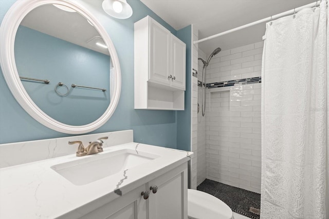 bathroom featuring vanity, toilet, and walk in shower