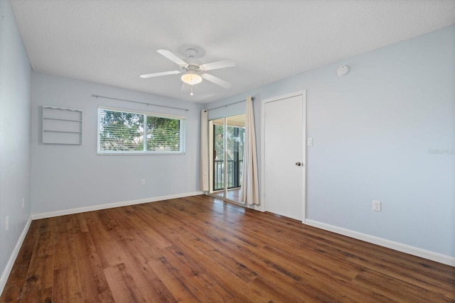 empty room featuring ceiling fan and dark wood-type flooring