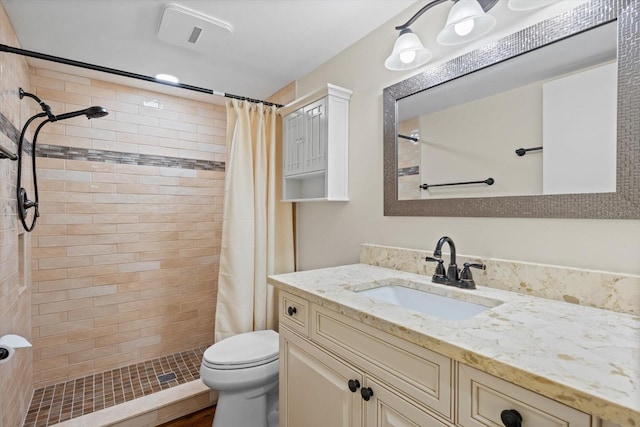 bathroom featuring a shower with curtain, vanity, and toilet