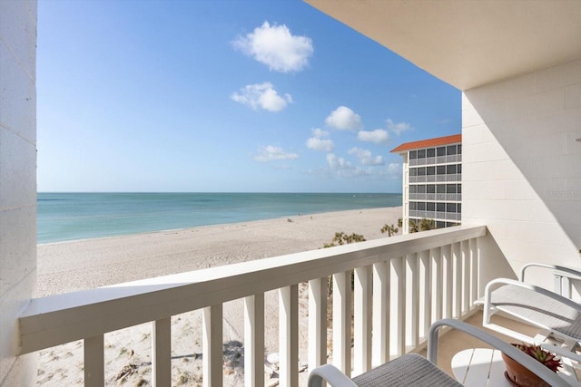 balcony featuring a beach view and a water view