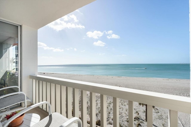 balcony with a beach view and a water view