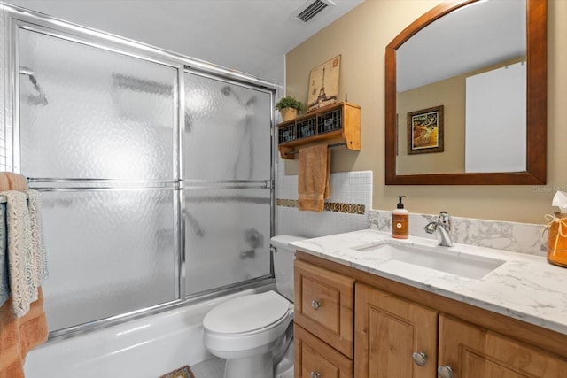 full bathroom featuring vanity, toilet, and enclosed tub / shower combo