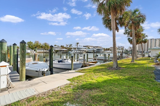 view of dock featuring a lawn and a water view