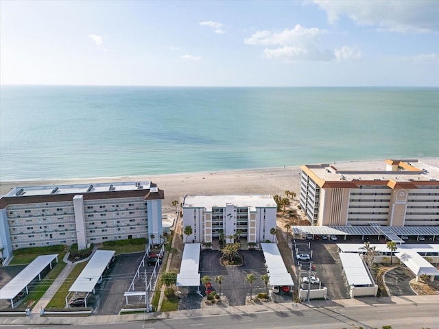 aerial view with a water view and a beach view