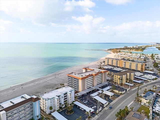 drone / aerial view featuring a water view and a view of the beach