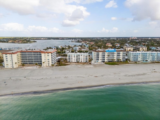 birds eye view of property featuring a water view and a beach view