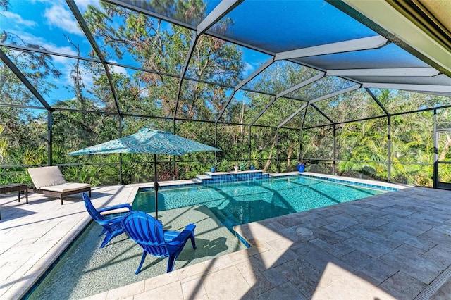 view of pool featuring a patio and glass enclosure