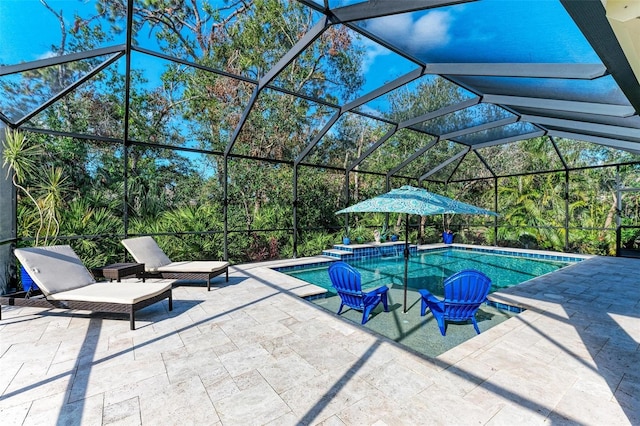 view of pool featuring glass enclosure and a patio area