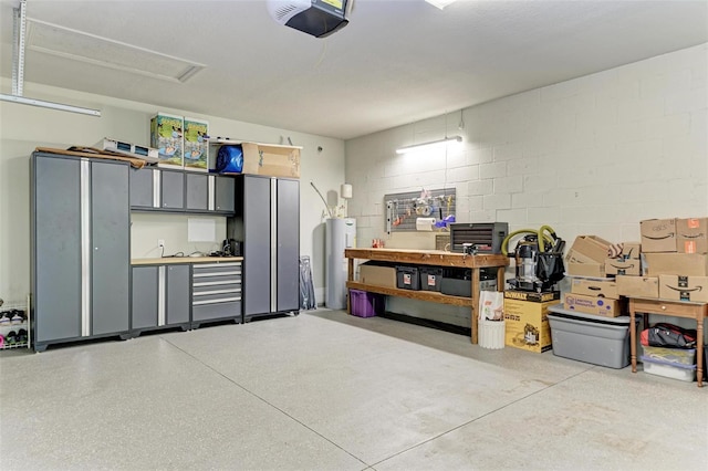 garage featuring water heater and a garage door opener