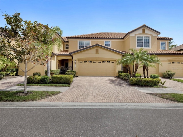 mediterranean / spanish-style house with a garage