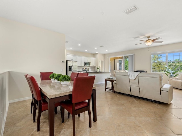 tiled dining area featuring ceiling fan