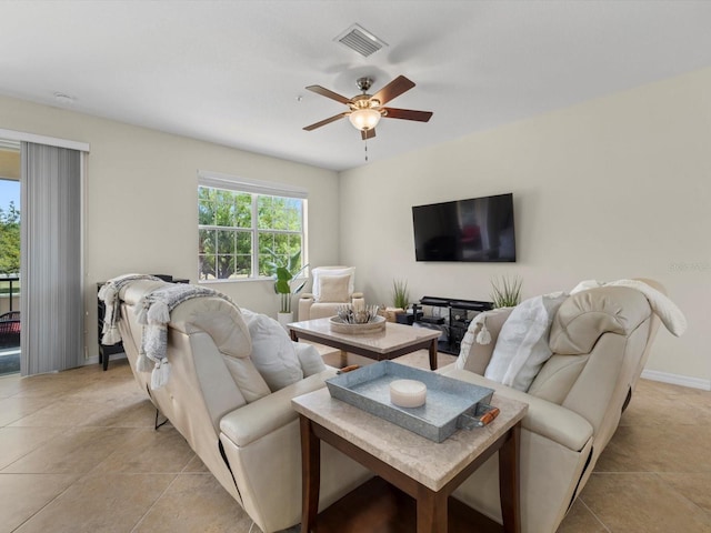 living room with ceiling fan and light tile patterned flooring