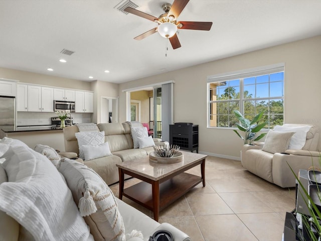 living room featuring ceiling fan and light tile patterned floors