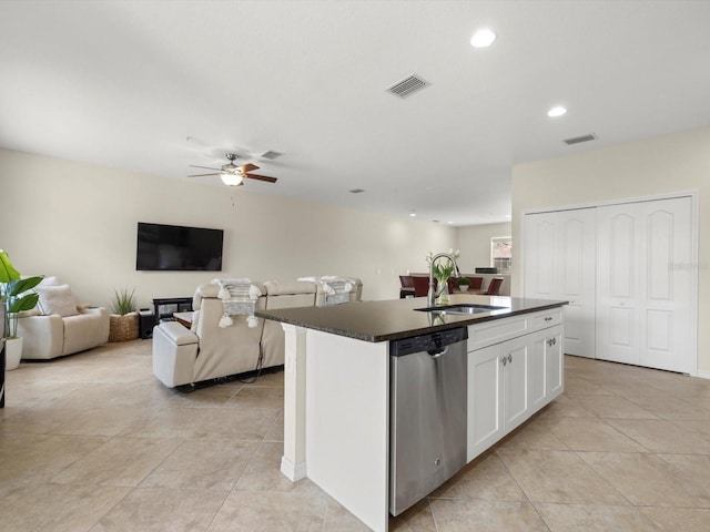 kitchen with white cabinets, stainless steel dishwasher, a kitchen island with sink, and sink