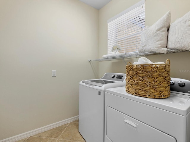 clothes washing area featuring light tile patterned flooring and independent washer and dryer