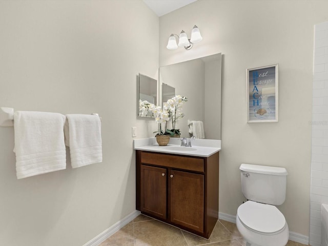 bathroom featuring tile patterned floors, vanity, toilet, and a washtub