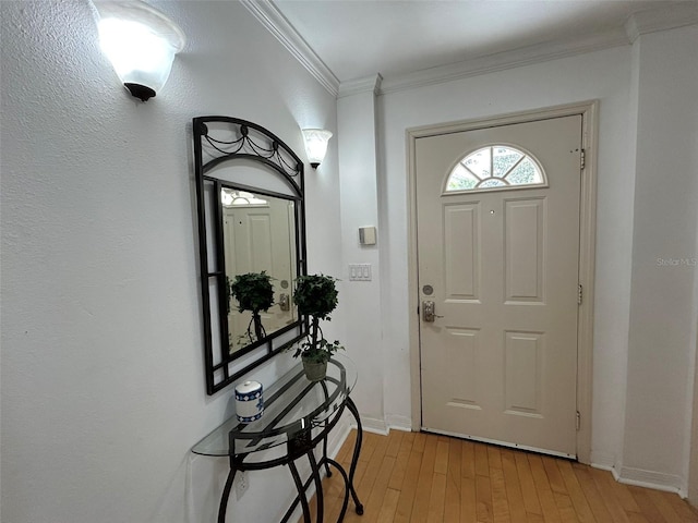 foyer featuring crown molding and light wood-type flooring