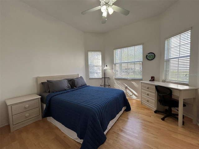 bedroom with ceiling fan and light hardwood / wood-style floors