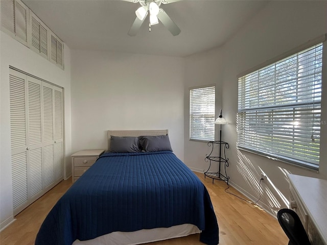 bedroom featuring ceiling fan, light hardwood / wood-style flooring, and a closet