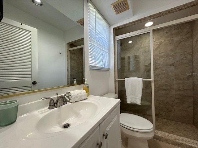 bathroom with vanity, toilet, and an enclosed shower