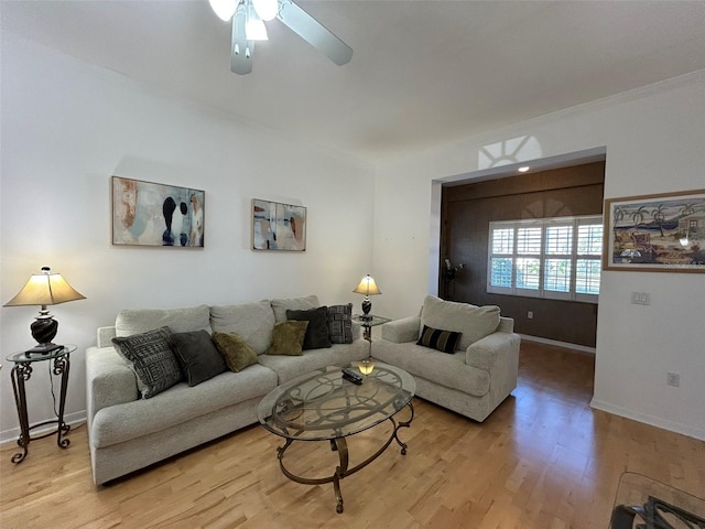 living room with ceiling fan, crown molding, and light hardwood / wood-style flooring