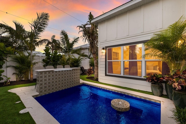 view of pool at dusk