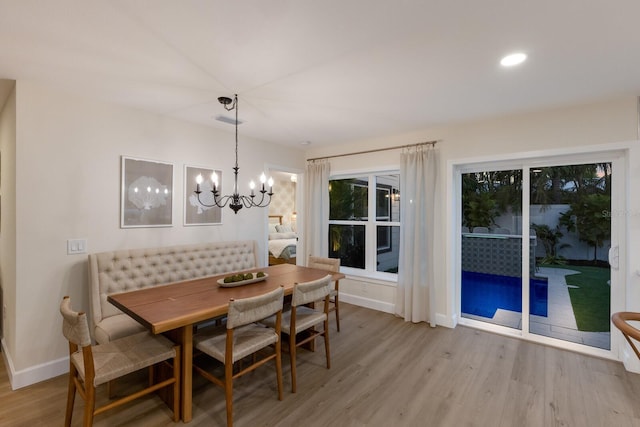 dining area with an inviting chandelier and light wood-type flooring