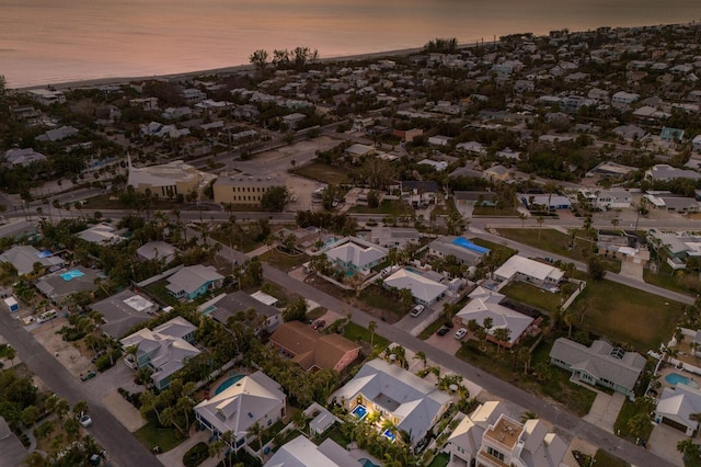 aerial view at dusk with a water view