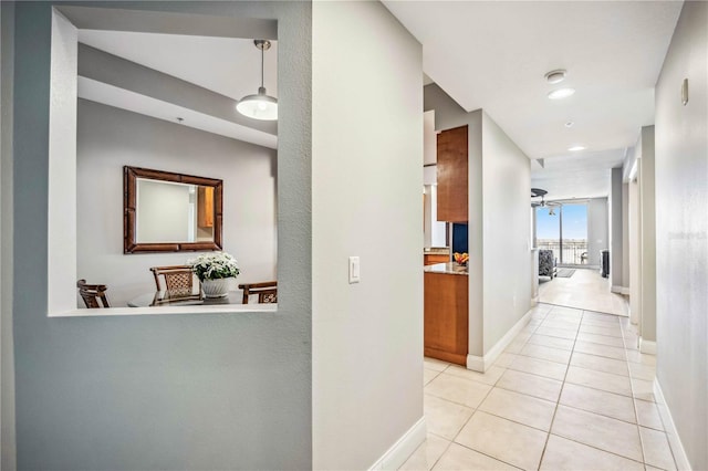 corridor featuring floor to ceiling windows and light tile patterned floors