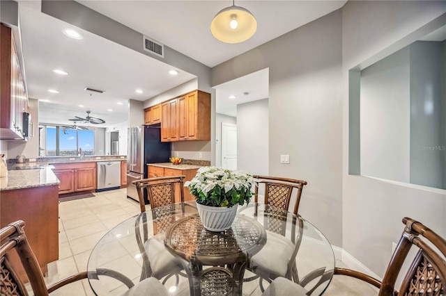 dining space with sink and light tile patterned flooring