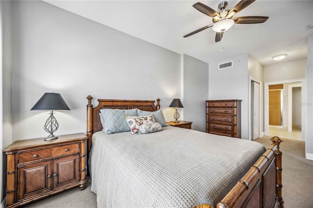 carpeted bedroom with connected bathroom, a closet, and ceiling fan