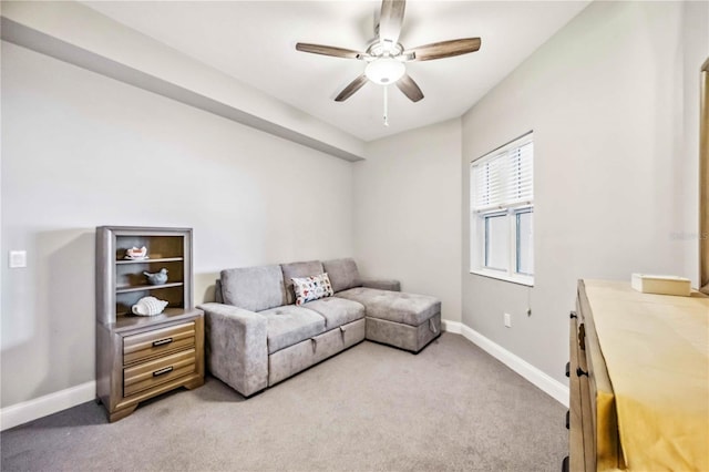 carpeted living room featuring ceiling fan