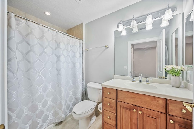 bathroom featuring tile patterned floors, vanity, toilet, and a textured ceiling