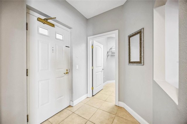 corridor featuring light tile patterned floors