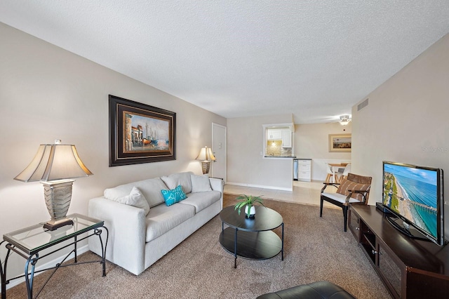 carpeted living room with a textured ceiling