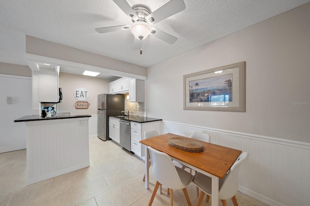 interior space with a textured ceiling and ceiling fan