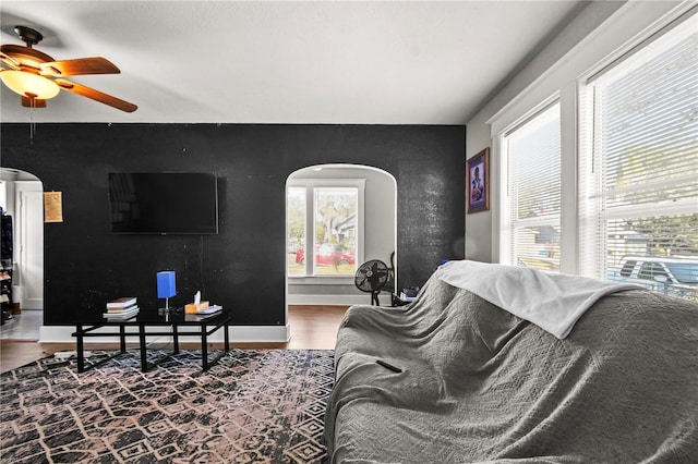 living room with hardwood / wood-style floors, ceiling fan, and a healthy amount of sunlight