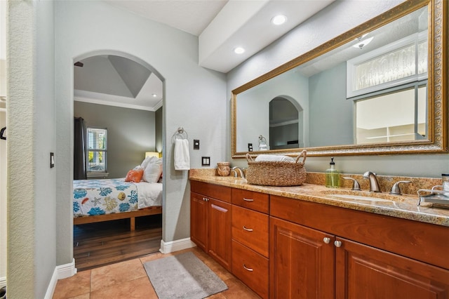 bathroom with crown molding, vanity, and hardwood / wood-style flooring