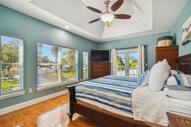 bedroom featuring access to outside, ceiling fan, french doors, and wood-type flooring