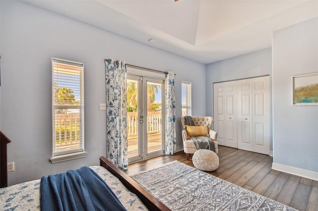 bedroom featuring french doors, access to outside, a closet, and dark hardwood / wood-style floors