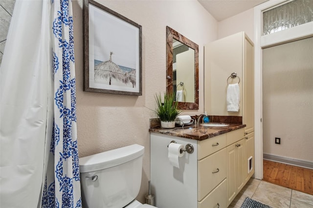 bathroom featuring hardwood / wood-style flooring, vanity, and toilet