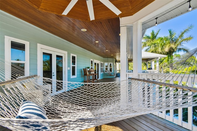 wooden terrace featuring ceiling fan and french doors