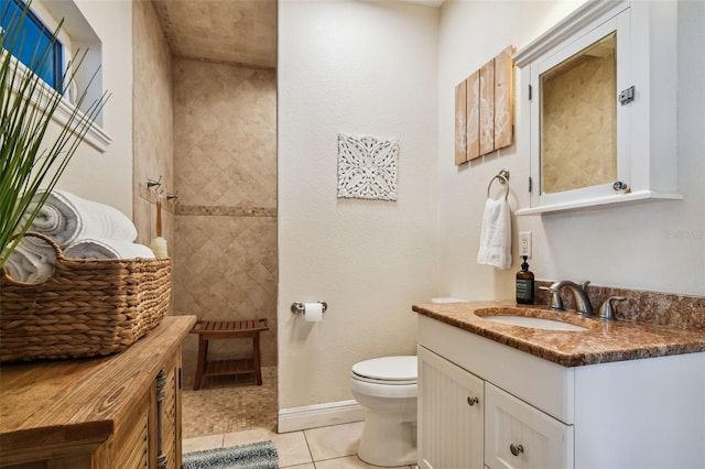 bathroom featuring tile patterned flooring, vanity, and toilet