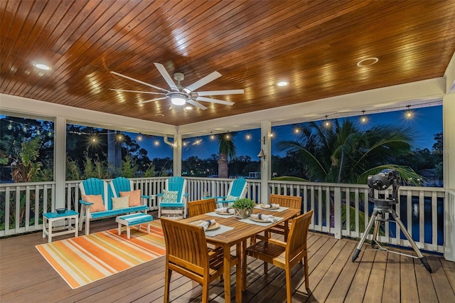 sunroom with ceiling fan and wooden ceiling