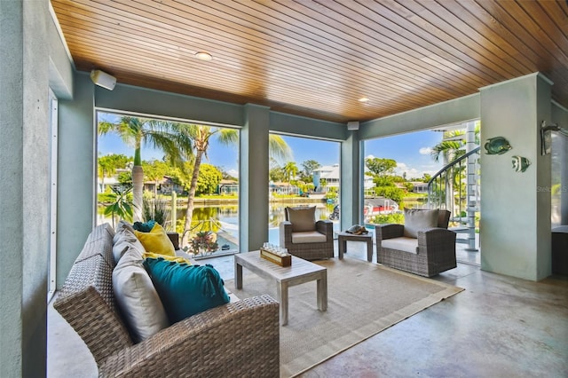 sunroom / solarium with a water view and wood ceiling