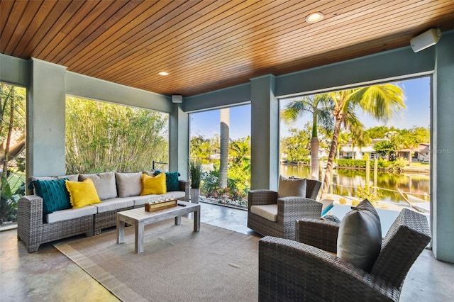 sunroom featuring a water view and wood ceiling