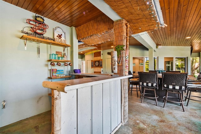 kitchen with wooden ceiling and concrete floors