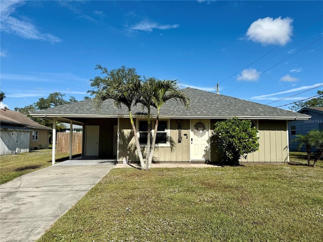 single story home featuring a front yard and a carport